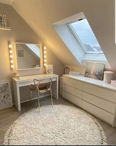 an attic bedroom with white furniture and lights on the windows sill, along with a large rug