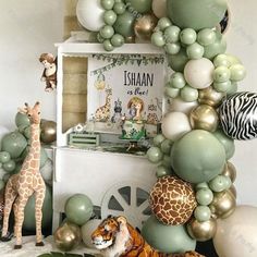 an animal themed birthday party with balloons and giraffes