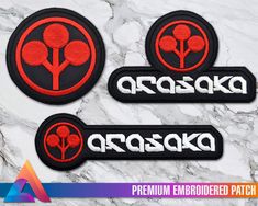 three embroidered patch designs with the words arasaka in white and red on a marble background