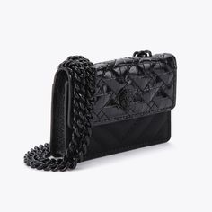 The Micro Drench Kensington is crafted from a faux lambskin leather with croc, lizard and textured panels. The black eagle head features crystals and black bead eyes on the front flap. 2.8in (H), 3.9in (L), 0.8in (D)Strap drop cross body: 48.4inBlack metal chain strapMagnetic snap closure hidden under flapBlack metal branded plate on the backCan fit classic credit cardsMaterial: Leather alternativeStyle number: 3536700979 Micro Kurt Geiger, Knee Boots Flat, Micro Bags, Textured Panels, Micro Bag, Black Eagle, Handbag Collection, Girly Bags, Swimming Bag