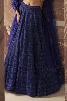 Indigo blue lehenga with bead and crystal embellished floral motifs. Comes with embellished blouse and dupatta.
Components: 3
Pattern: Embroidered
Type Of Work: Sequin,Crystal
Neckline: V-neck
Sleeve Type: Sleeveless
Fabric: Blouse and Lehenga: Net, Dupatta: Organza 
Color: Blue
Other Details: 
Bead tasselled blouse
Closure: 
Lehenga: Side Drawstring
Blouse: Side zip
Occasion: Bride,Wedding - Aza Fashions Blue V-neck Sets With Resham Embroidery, Blue V-neck Bollywood Style Sets, Blue Embellished Dupatta For Reception, Traditional Blue Embellished Sharara, Blue Embellished Lehenga For Diwali, Elegant Blue Embellished Lehenga, Embellished Blue Lehenga With Traditional Drape, Blue Semi-stitched Embellished Lehenga, Traditional Blue Embellished Lehenga