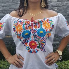 Beautiful colorful Hand Embroidered Mexican Flower Shirt made in Chiapas, Mexico. Cotton Shirt can be machine washed in cold water, hang to dry and warm iron. Each shirt is hand embroidered and flower will vary but each one is beautiful and unique Any questions please feel free to contact me DOES NOT INCLUDE THE BELT White Traditional Tops With Traditional Patterns, Fitted Summer Tops With Motifs, Bohemian Embroidered Top With Multicolor Motif, Bohemian Tops With Multicolor Embroidery And Motif, Festival Embroidered Multicolor Top, Multicolor Folk Tops With Woven Motifs, Folk Style Multicolor Tops For Cinco De Mayo, Multicolor Folk Tops For Cinco De Mayo, Folk Style Multicolor Tops With Woven Motifs