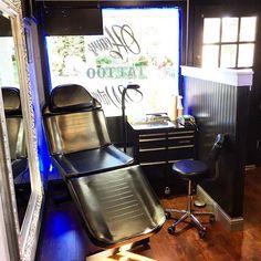 a barber chair sitting in front of a mirror