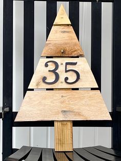 a wooden christmas tree with the number 35 on it