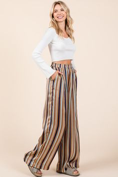 These wide-leg pants in a striped print and dull satin woven fabric offer a chic and comfortable style. Featuring a smocked elastic waist for an easy fit, they provide both comfort and versatility. The addition of side pockets adds functionality, while the short lining ensures modesty and ease of movement. With a relaxed fit and full-length design, these pants are perfect for casual outings or dressy occasions, making them a stylish addition to any wardrobe. Pair them with a fitted top for a bal Fall Outfits School, Comfortable Style, Fitted Top, Striped Pants, Comfortable Fashion, Women's Tops, Bottoms Pants, Leg Pants, Jumpsuit Dress