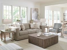 a living room filled with lots of furniture and decor on top of carpeted flooring