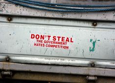 a sign on the back of a truck that says don't steal the government hates competition