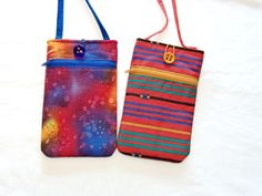 Need a place to carry your cell phone and other small essentials as you are out and about? These bags will do that for you. They measure 3 3/4" X 6 3/4" on the INSIDE for your phone and closes with a fabric or elastic loop and pretty button. The 5" deep zipper pocket will keep your ID, card, cash, keys, and other small essentials safe and the 1/4" X 50" strap can be worn crossbody, or with a quick tie up, a shoulder bag. They are lightly padded with fleece to protect the contents from bumps. Pattern placement and button may vary from the ones shown. Don't let it get away--order today! Bags are described as follows: Burnt orange, royal blue, and yellow design Burn orange background with teal, blue, and gold horizontal stripes  Check out my other listings at https;//www.etsy.com/shop/Designe Multicolor Phone Bag With Cell Phone Pocket As Gift, Multicolor Phone Bag With Adjustable Strap As Gift, Multicolor Square Phone Bag For Everyday Use, Everyday Multicolor Rectangular Phone Bag, Multicolor Phone Bag With Cell Phone Pocket For Travel, Square Phone Bag With Cell Phone Pocket, Everyday Square Phone Bag With Cell Phone Pocket, Rectangular Everyday Zipper Phone Bag, Multicolor Phone Bag With Cell Phone Pocket