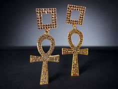 These are so unique  glam Ankh style Beautiful bling Gold metal with clear sparkle rhinestones  They are very lightweight  They hang 4 inches handmade original design Classic rhinestone Ankh and pyramid symbol  Great addition to any unique wardrobe Gold Rhinestone Metal Earrings, Gold Metal Earrings With Rhinestones, Gold Rhinestone Earrings For Gift, Gold Earrings With Rhinestones For Gift, Gold Rhinestone Crystal Earrings, Gold Crystal Earrings With Rhinestones Gift, Gold Crystal Earrings With Rhinestones, Gold Crystal Rhinestone Dangle Earrings, Gold Crystal Earrings With Bling As Gift