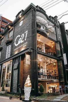 an ice cream shop on the corner of a street in front of a tall building