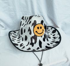 Embellished cow print cowboy hat. Perfect addition to your bachelorette weekend, birthday party, or themed event. Hats are made to order. Allow 5-7 business days for the assembly of your hat, in addition to shipping time. This item is not returnable. Message us if you're interested in customization! Cow Print Fashion, Smiley Face Cowboy, Cow Print Cowboy Hat, Cowboy Hat Design, Custom Cowboy Hats, Bachelorette Hats, Preppy Party, Diy Crafts Bookmarks, Crazy Hats