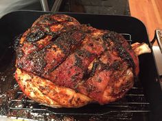 a large piece of meat sitting on top of a grill