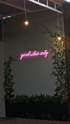 a neon sign that reads good luck is on display in front of a white wall