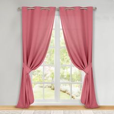 a window with pink curtains and a rug on the floor in front of an open window