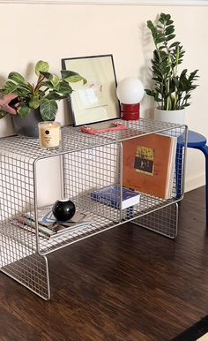 a table with some books and plants on it