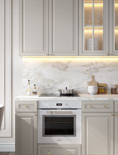 a kitchen with white cabinets and marble counter tops, along with an oven in the center