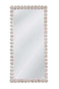 a white mirror with beaded trim around it