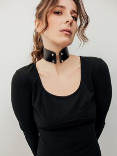 Show off your gothic side with the Sabrina Choker, a striking accessory made from leather and adorned with solid stainless steel barbels and screws. This choker is perfect for those who want to make a statement and add a touch of edge to their outfit. Whether you're attending a concert or a night out with friends, the Sabrina Choker is the ideal choice for elevating your style game Edgy Choker For Alternative Fashion, Rocker Style Festival Choker Jewelry, Edgy Black Choker For Alternative Fashion, Edgy Adjustable Rivets Choker, Edgy Rivets Jewelry, Edgy Choker For Festivals, Gothic Jewelry With Rivets For Alternative Fashion, Black Rivets Jewelry For Alternative Fashion, Marsala Color