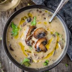 a bowl of soup with mushrooms and parsley