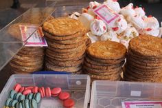 there are many cookies and other treats on the display table in front of each other