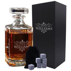 a bottle of william's whisky next to some ice cubes and a black box