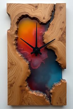 a clock made out of wood with an abstract painting on it