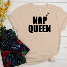 T-Shirt Text: Nap Queen For the Napper of ALL NAPPERS, who love taking naps more than anything else. This cute text design says "Nap Queen" for people who love napping and sleeping. This item is NOT available in stores. Inspiring Picks is the ONLY AUTHORIZED SELLER of this T-Shirt. ◾ Product Details ◾ We offer high-quality fabrics combined with equally high-quality printing using eco-friendly ink directly into the fabric. Washing durability is fantastic. PREMIUM UNISEX T-SHIRT: The Bella Canvas Novelty Crew Neck Top With Funny Text, Funny Slogan Tops In Ring-spun Cotton, Trendy Birthday Tops With Funny Text, Trendy Tops With Funny Text In Ring-spun Cotton, Relaxed Fit Birthday Slogan T-shirt, Birthday Slogan T-shirt Relaxed Fit, Funny Text Print Tops In Ring-spun Cotton, Trendy Ring-spun Cotton Top With Funny Text, Relaxed Fit Tops With Funny Text For Birthday