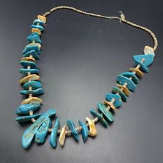 "VINTAGE NAVAJO TURQUOISE NECKLACE DESCRIPTION: This impressive strand features gorgeous specimens of polished Easter Blue turquoise and orange spiny oyster shell spaced with fine hand-rolled shell heishi. This breathtaking necklace will be a valuable addition to your collection of fine vintage Native American jewelry. MEASUREMENTS: Necklace measures 30\" end to end Large turquoise specimen measures 60mm long Beads are securely strung on natural fiber WEIGHT: 168.0 grams SIGNED: no" Blue Shell-shaped Adjustable Necklace, Vintage Turquoise Single Strand Necklace, Handmade Blue Shell-shaped Necklace, Vintage Blue Gemstone Bead Necklace, Southwestern Style Blue Necklace For Beach, Southwestern Blue Beach Necklace, Blue Southwestern Style Beach Necklace, Southwestern Style Blue Beach Necklace, Southwestern Style Necklaces With Natural Stones For Beach