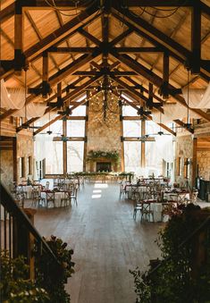 the inside of a large building with tables and chairs set up for an event or function