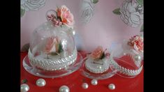 three cakes with flowers and pearls on a red table