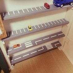 toy cars are lined up on the shelves