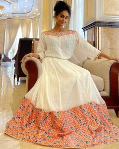 This stunning Ethiopian Habesha dress showcases the beauty of traditional craftsmanship and the luxurious feel of Menen fabric. The lower part of the dress is handwoven with great care and attention to detail, resulting in a beautiful and unique texture that is sure to turn heads. The Menen fabric used in this dress is of the highest quality, adding a luxurious feel to the overall design. The dress features a beautiful and elegant design that highlights the traditional techniques used in its cre Habesha Wedding, Eritrean Dress, Ethiopian Clothing, Habesha Dress, Ethiopian Traditional Dress, Ethiopian Dress, Habesha Kemis, Classy Gowns, Paris Outfits