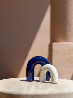 a small blue and white object sitting on top of a table next to a building