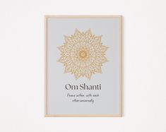 a framed print with the words on shanti in gold and white, against a light gray background