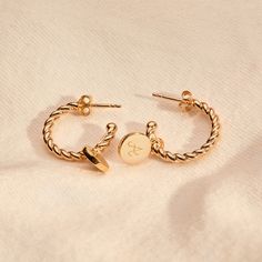 This set of Personalized Entwined Hoop Earrings features a twisted rope design, paired with delicate hand-engraved pendants with the initial that means the most.18K Champagne Gold PlatedHoop: 0.7 diameterDisc: 0.3 diameterHand engraved in our Paris workshopSent with love in a complimentary gift boxAny slight variations in lettering depth, spacing and alignment from the examples shown are part of the aesthetic and originality of the piece Engraved Initials, Initial Earrings, Hoop Charms, Engraved Pendant, Metal Engraving, Rope Design, Champagne Gold, Hand Engraving, Bridal Accessories