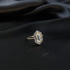 This stunning ring is set in 14k Solid Yellow Gold with Natural White Topaz with utmost precision. It is a unique statement gemstone ring for nearly every occasion and is completely hassle-free jewelry. ITEM DETAILS: * CENTER GEM: White Topaz * GEM SIZE: 10X5mm * GEM SHAPE: Fancy * SIDE GEM: White Topaz * GEM SIZE: 1.2mm (25 pcs) * GEM SHAPE: Round * Total Gem weight: 1.77 carats * Gold Purity: 14KT (58.33% approx.) * Gold Weight: 1.61 gram * Total Weight of the Ring: 1.96 gram The Gold purity i Elegant Octagon Topaz Ring For Wedding, Heirloom Octagon Rose Cut Diamond Ring, 14k Gold Halo Ring With Emerald-cut Center Stone, 14k Gold Emerald Cut Halo Ring With Center Stone, 14k Gold Art Deco Ring With Center Stone, Art Deco 14k Gold Rings With Center Stone, Art Deco 14k Gold Ring With Center Stone, Yellow Gold Octagon Topaz Ring For Anniversary, Octagon-shaped Halo Jewelry For Anniversary