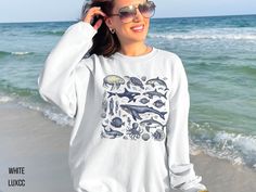 Ocean Inspired Style Coconut Girl Sweatshirt Beach Vibes Sweater Gift for Her Whales Sea Shell Orca Apparel Sea Animal Beachy Shirt  Welcome to LuxCC! We're thrilled to have you here and can't wait to share our collection of stylish and comfortable apparel with you. Whether you're looking for a casual, everyday piece or something a bit more unique, we've got you covered. As a small business, we truly appreciate your support. Every purchase you make helps us continue to do what we love and bring Summer Beach Crew Top, Summer Beach Crew Neck Tops, Summer Beach Tops With Crew Neck, Beach Vibes, Sweater Gift, Gildan Sweatshirts, Girl Sweatshirts, Ocean Inspiration, Beach Vibe