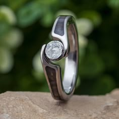 a close up of a ring on top of a rock