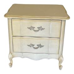 a white dresser with two drawers sitting on top of it