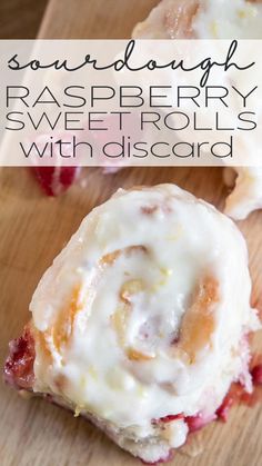 a close up of a pastry on a wooden surface with the words sourdough raspberry sweet rolls with dissocard