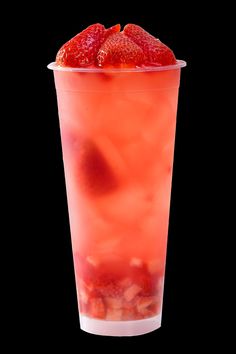 a drink with strawberries in it on a black background