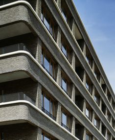 an apartment building with windows and balconies