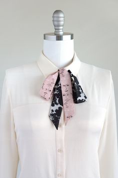 "Black, white, and pink neck scarf in a shadow bouquet/face print mix. Ready to ship, special edition midi-length skinny scarf designed by Cinne. Full of character with endless styling possibilities. Wear around your neck, in your hair, tied on your favorite bag, or around your wrist. Find more styling examples in second to last photo. Constructed entirely by hand with love and attention to every detail. . . . . . . . . . . . . . . . . . . . . . . . . . . . . . . . . . . . . . . . . . . . . . . Trendy Pink Scarves One Size, Trendy Pink Scarves, Black Silk Scarf As Summer Gift, Black Silk Scarf For Summer Gift, Chic Pink Scarf As Gift, Chic Scarves With Ties, Trendy Scarves For Spring Gift, Chic Adjustable Scarves With Ties, Trendy Spring Scarves