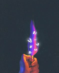 a person holding a lighter in their hand with the light shining on it's side