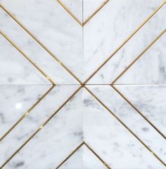 white and gold marble tile with golden lines on the edges, in an angled pattern