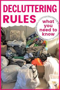 a pile of clothes sitting on top of a floor next to a pink sign that says decluttering rules