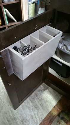 an open drawer in the middle of a cabinet