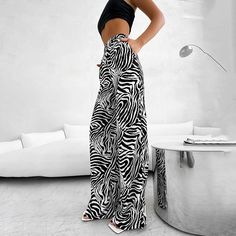 Make a statement with these zebra stripe wide-leg summer pants, the perfect addition to your casual wardrobe. Crafted from a soft and comfortable fabric with stretch, these pants feature a trendy street style design that is sure to turn heads. The elastic waistband ensures a comfortable fit, while the side stripe detail adds a touch of sporty chic. Whether you're running errands or grabbing lunch with friends, these pants are perfect for any casual occasion. Plus, they come in petite and short s Trendy Striped Wide Leg Pants, Trendy Striped Wide-leg Pants, Summer Zebra Print Wide Leg Bottoms, Spring Wide Leg Zebra Print Pants, Trendy Striped Wide Leg Pants For Spring, Casual Zebra Print Bottoms For Summer, Spring Wide Leg Zebra Print Bottoms, Casual Zebra Print Summer Bottoms, Casual Wide Leg Bottoms With Zebra Print