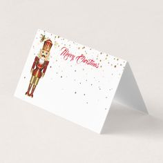 a christmas card with an image of a nutcracker in red and gold on it