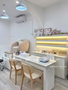 the interior of a nail salon with chairs and counter tops, lighted by overhead lights